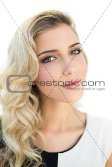 Slightly content smiling blonde model looking at camera