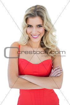Smiling blonde model posing with arms crossed