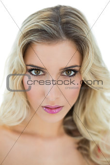 Serious blonde model looking passionately at camera