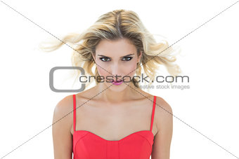 Mysterious smiling blonde model looking at camera