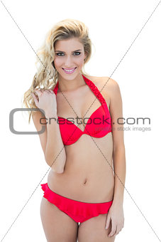 Attractive blonde model smiling at camera wearing red bikini