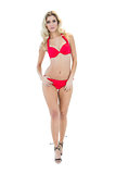 Seductive blonde model looking at camera wearing red bikini