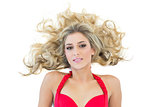 Attractive blonde model wearing red bikini looking at camera