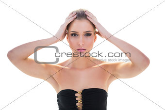 Serious attractive blonde model holding her head