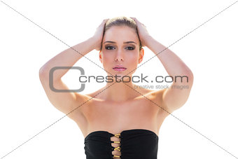 Stern attractive blonde model holding her head