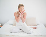 Natural cheerful blonde sitting in bed