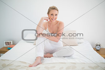Natural pretty blonde sitting on bed