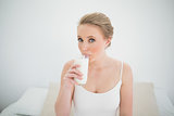 Natural content blonde drinking a glass of milk