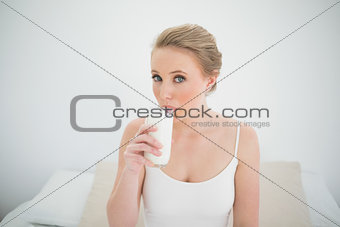 Natural content blonde drinking a glass of milk
