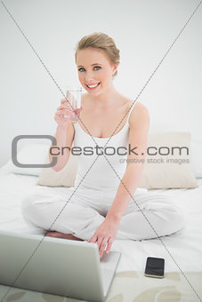 Natural cheerful blonde holding glass of water