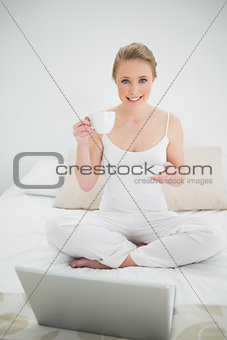 Natural cheerful blonde holding a cup