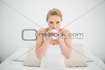Natural attractive blonde drinking from a mug