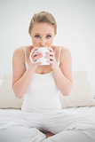 Natural pretty blonde drinking from a mug