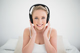 Natural smiling blonde listening to music