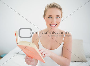 Natural smiling blonde holding a book