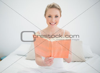 Natural happy blonde holding a book