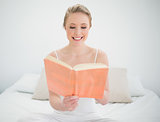 Natural happy blonde reading a book