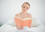 Natural thoughtful blonde reading a book