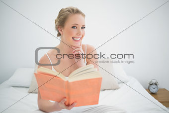 Natural cheerful blond holding a book