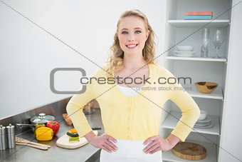 Smiling cute blonde standing hands on hips