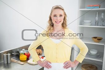 Cheerful cute blonde standing hands on hips