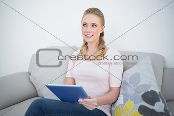Casual content blonde holding tablet