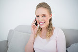 Casual cheerful blonde phoning