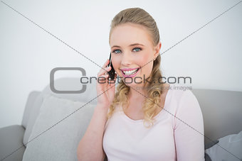 Casual cheerful blonde phoning
