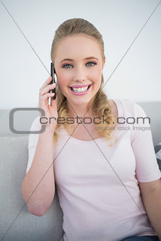 Casual happy blonde phoning