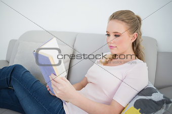 Casual content blonde reading a book