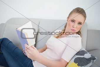 Casual content blonde holding a book