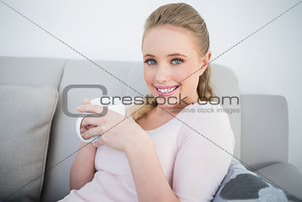 Casual cheerful blonde holding a mug