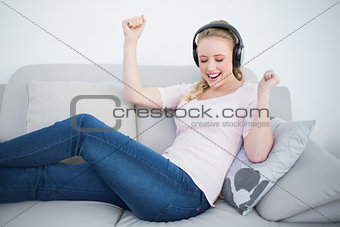 Casual partying blonde listening to music