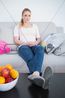 Casual content blonde sitting with feet on table