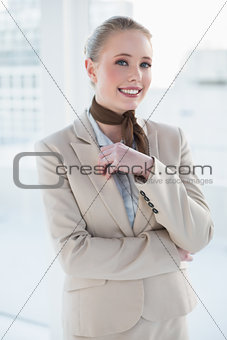 Blonde smiling businesswoman looking at camera