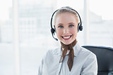 Blonde smiling businesswoman wearing a headset