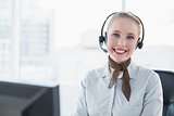 Blonde happy businesswoman wearing a headset