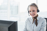 Blonde cheerful businesswoman wearing a headset