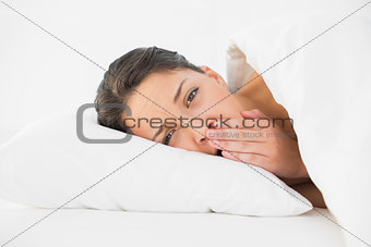 Tired casual brunette waking up and yawning