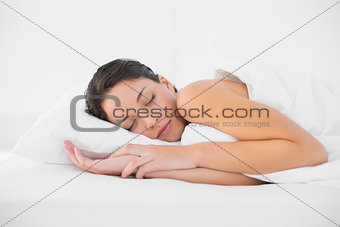 Cute casual brunette sleeping in her bed