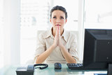 Troubled stylish brunette businesswoman praying