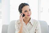 Content stylish brunette businesswoman making a phone call