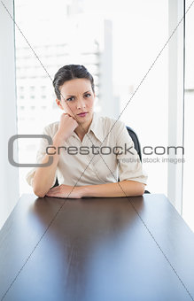 Irritated stylish brunette businesswoman posing looking at camera