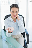 Pleased stylish brunette businesswoman presenting her hand
