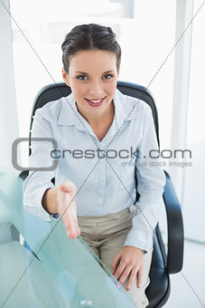 Content stylish brunette businesswoman presenting her hand