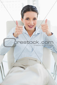 Content stylish brunette businesswoman giving thumbs up