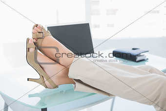 Close up of a businesswoman in high heels relaxing with feet up
