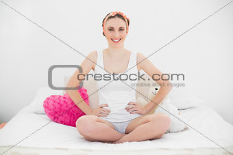 Smiling young woman with the hands on her hips