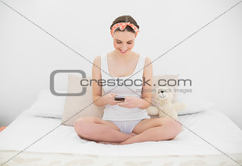 Young woman playing with her smartphone
