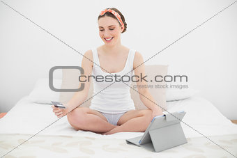 Young woman using her tablet for home shopping